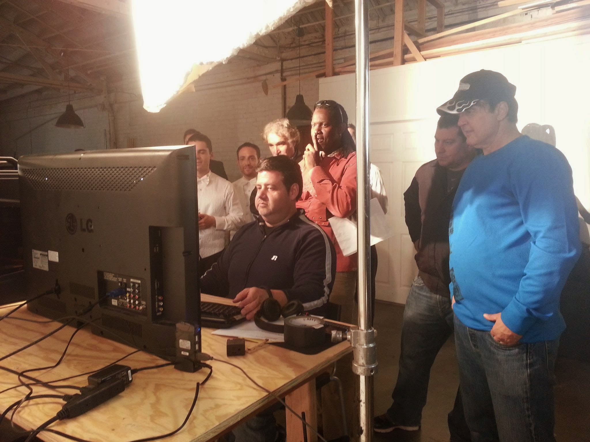 Stephen reviewing a monitor with a production team on set