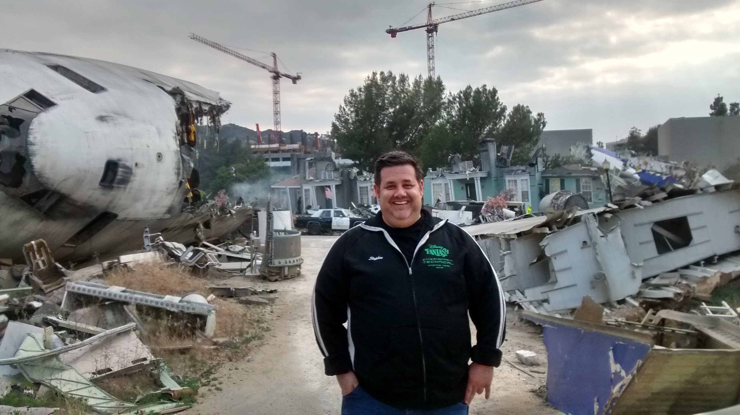 Stephen smiling on a practical airplane crash backlot