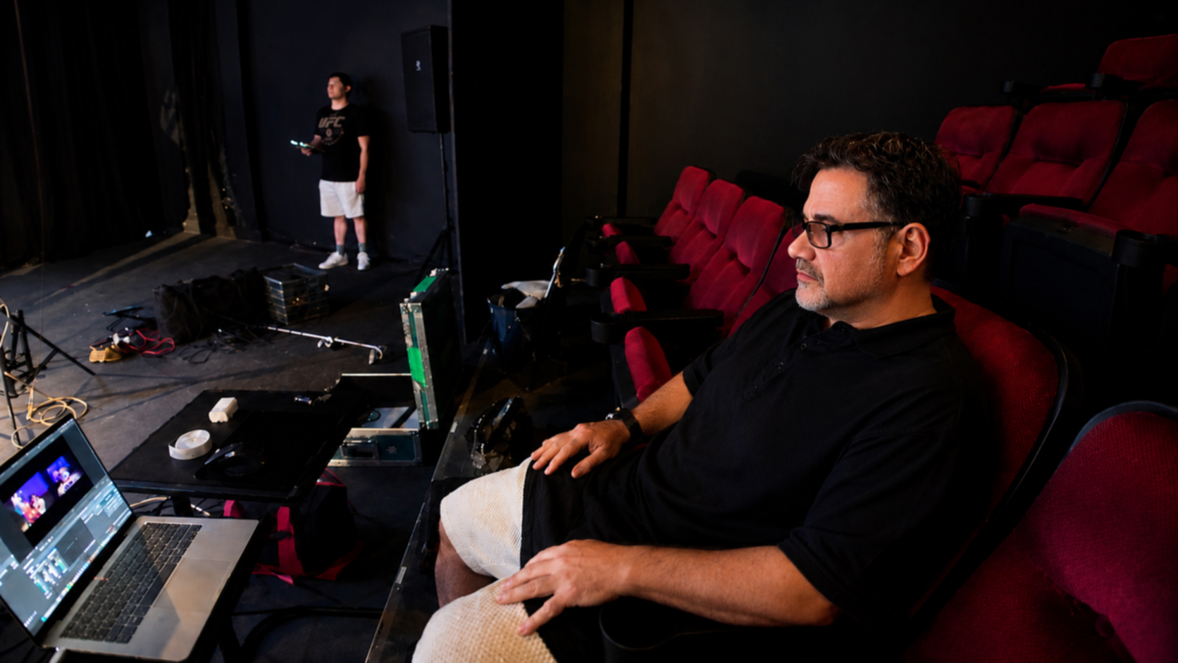 Stephen Robin reviewing a cut from a theater seat during production